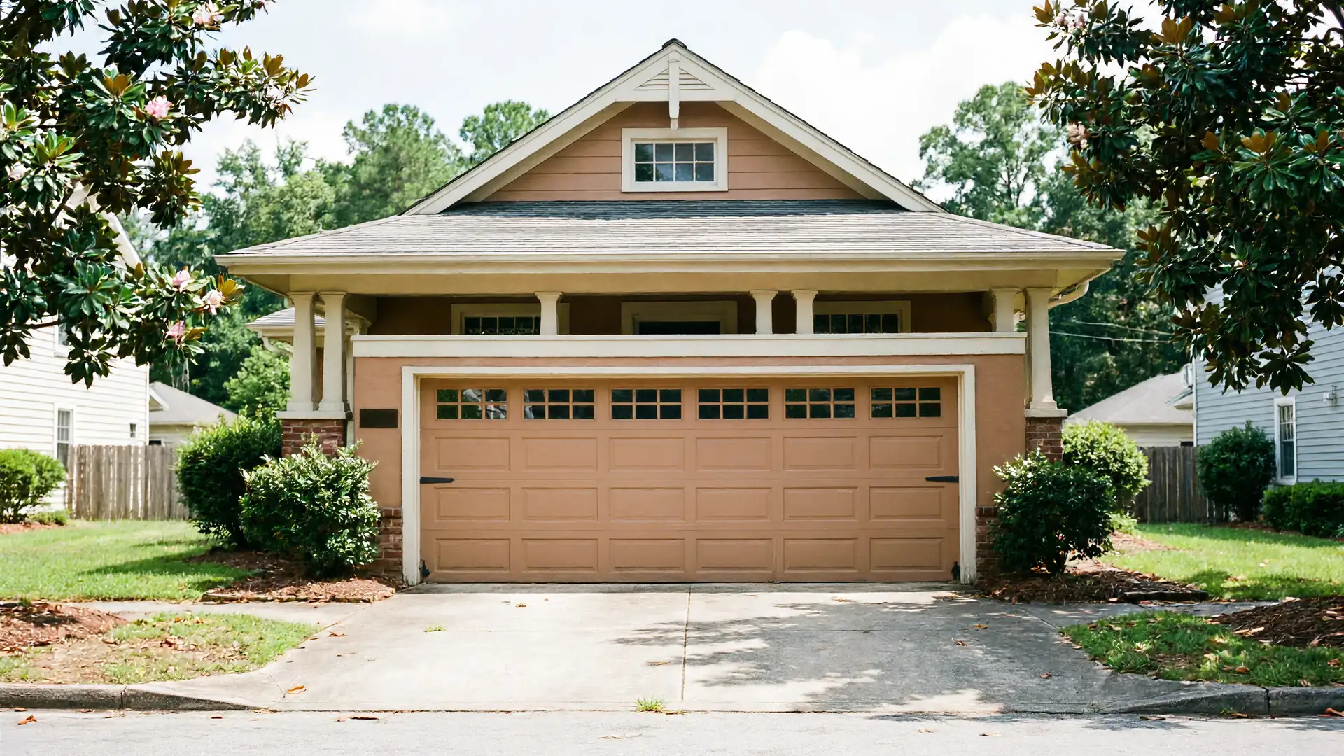 A brown house with a brown garage door is visible from the street.